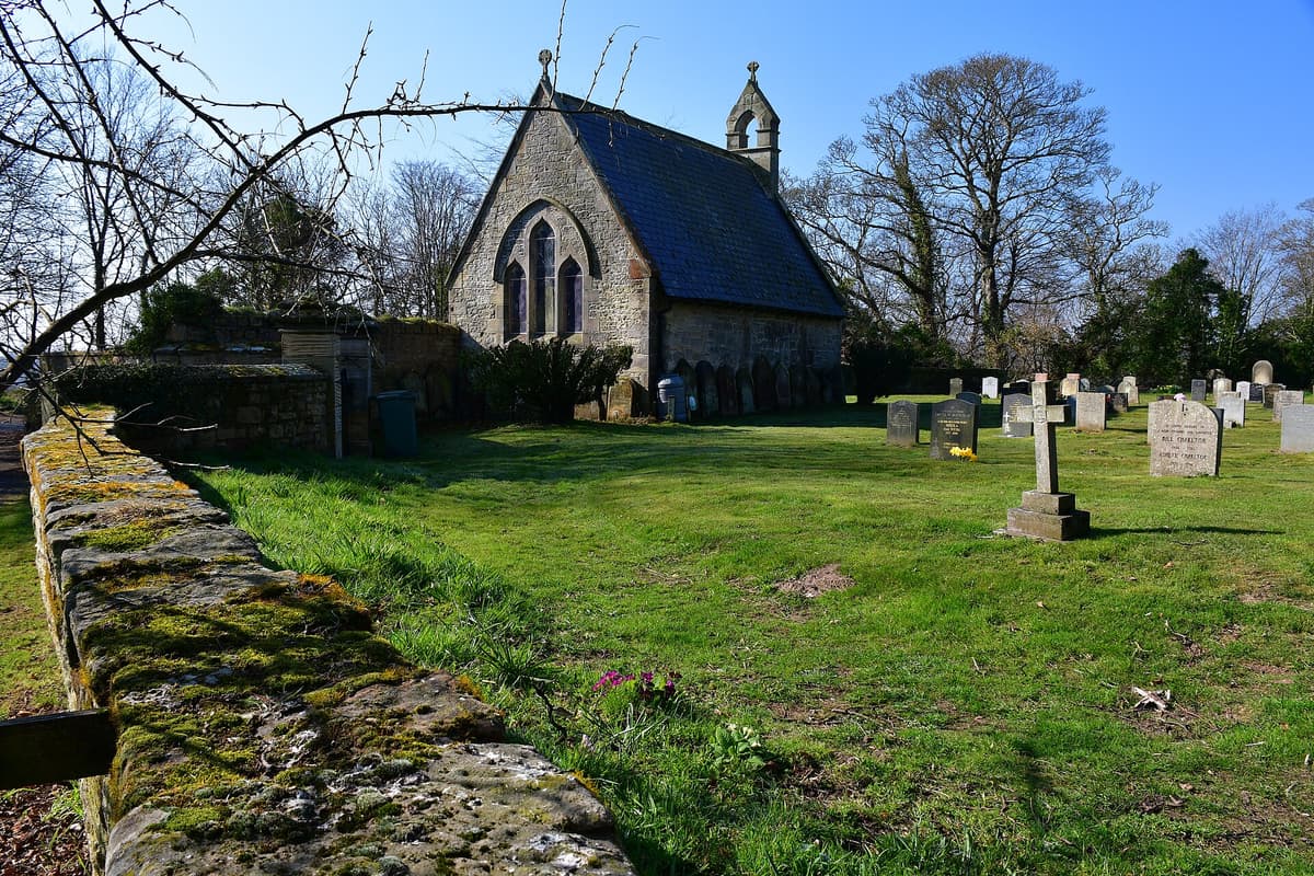 A small stone chapel among gravestones