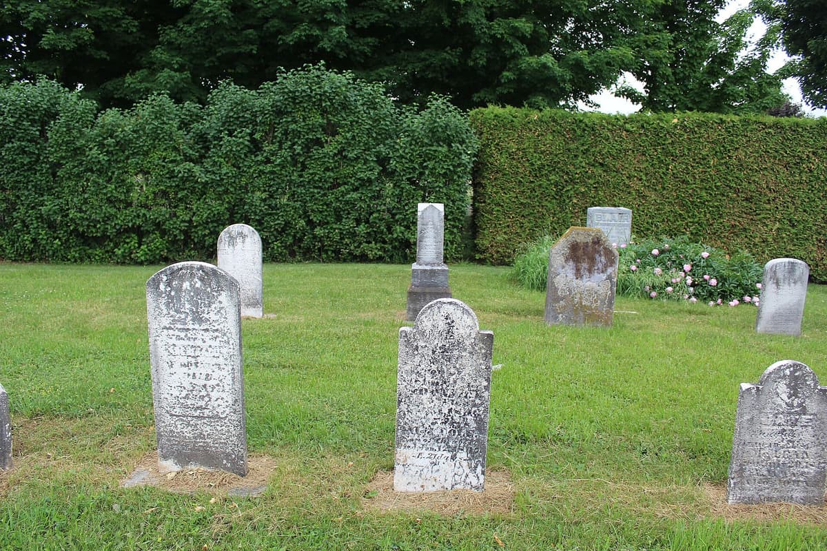 Rows of old headstones on a grassy slope